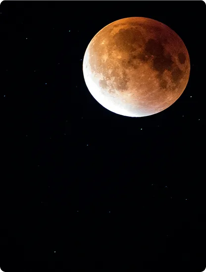 A copper-colored moon during an eclipse