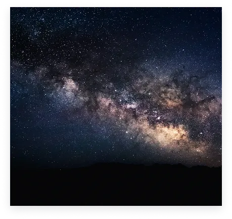 The Milky Way above a dark mountain horizon