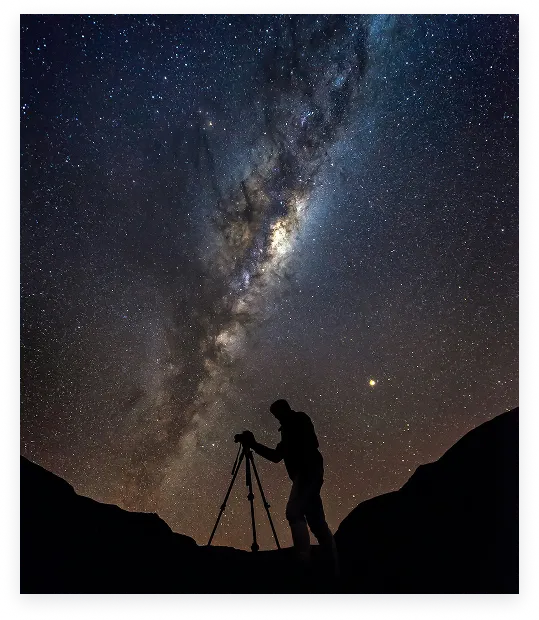 An astrophotographer working beneath the Milky Way